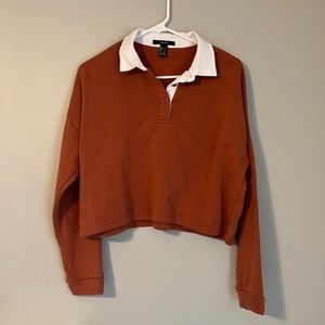 Burnt orange cropped collared shirt.